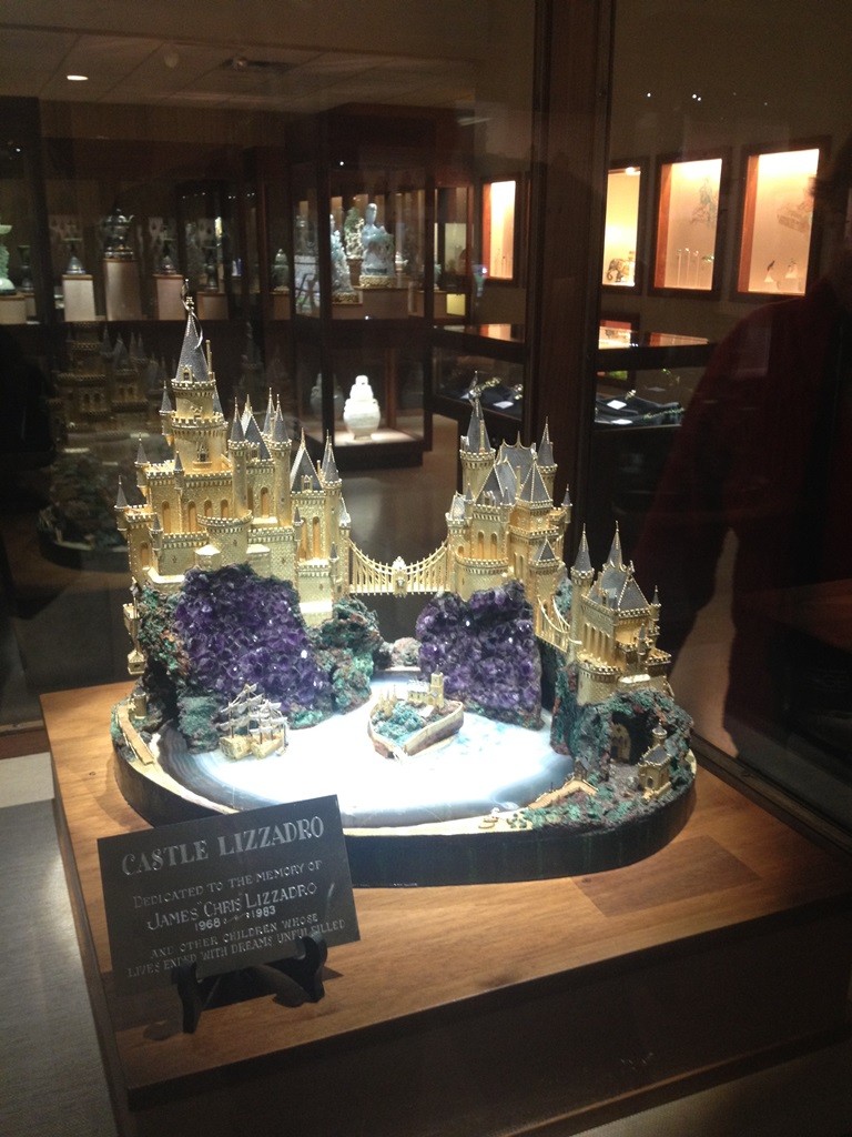 Castle Lizzadro 18k gold sculpture featuring windows of cut diamonds on a base of mineral specimens.