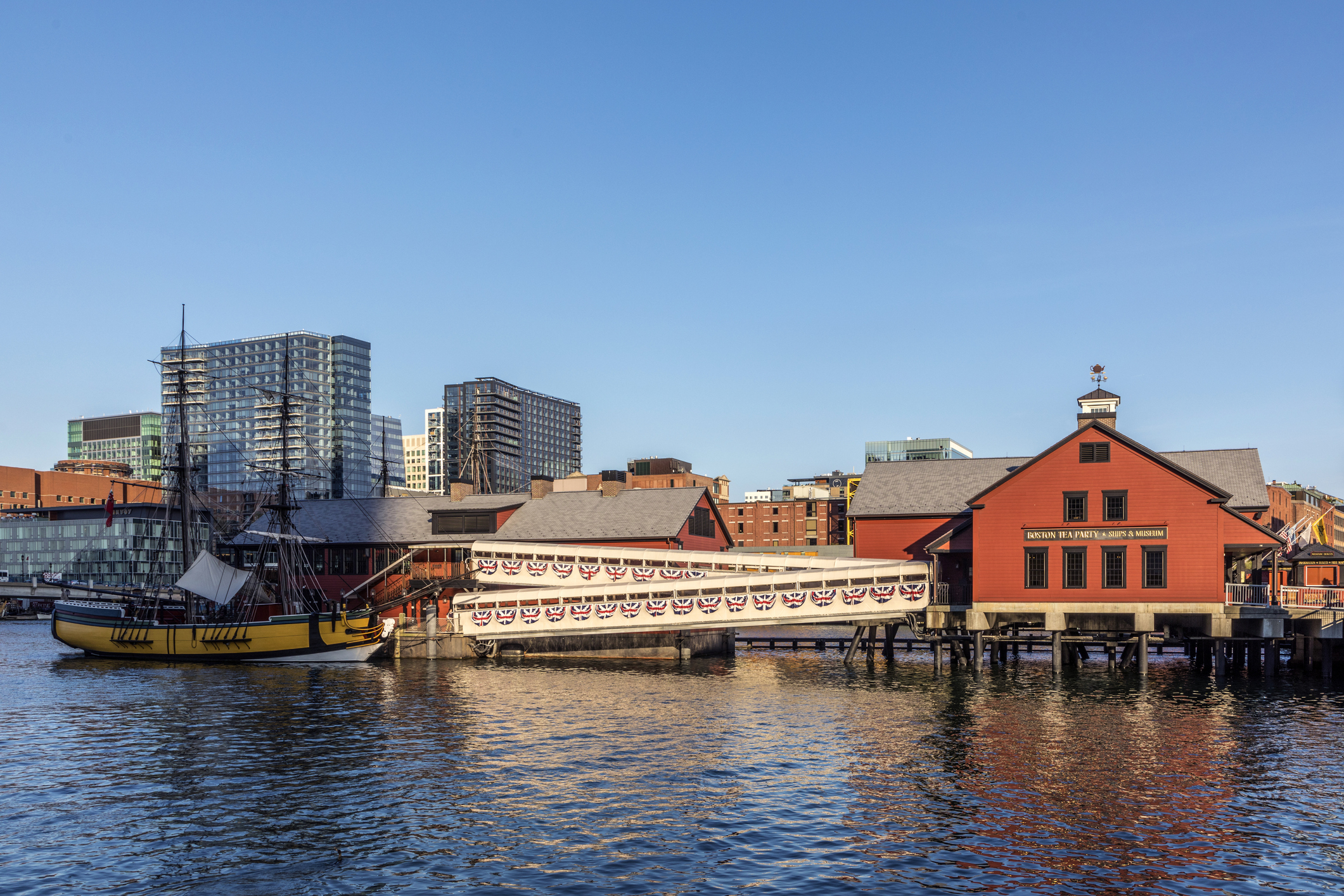 pier with historic building of the harbor site where the Boston tea party took place. in 1773