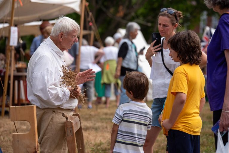 American Independence Museum in NH crafter speaking with kids. Photo credit American Independence Museum Facebook 768x512