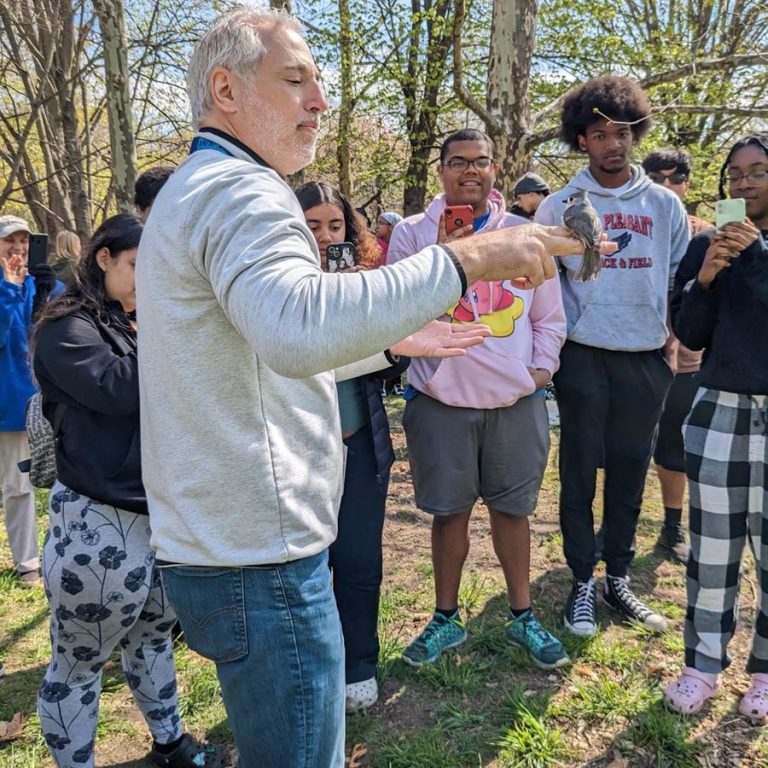 Audubon Society of Rhode Island hands on with a bird. Photo credit Audubon Society of Rhode Island Facebook 768x768