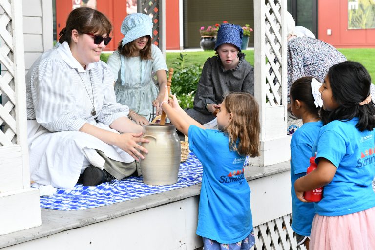 Naper Settlement churning butter. Photo credit Facebook 768x512