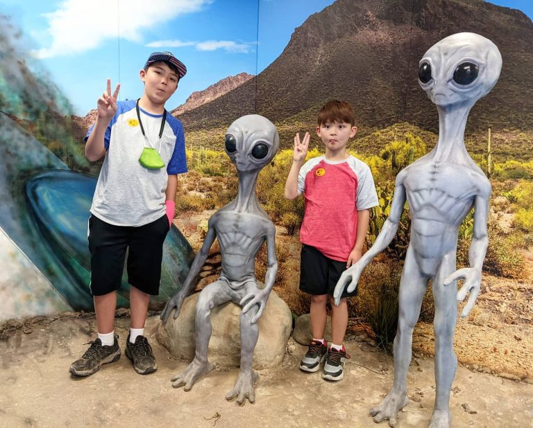 International UFO Museum Research Center visitors pose with aliens. Photo credit International UFO Museum Research Center Facebook 768x618