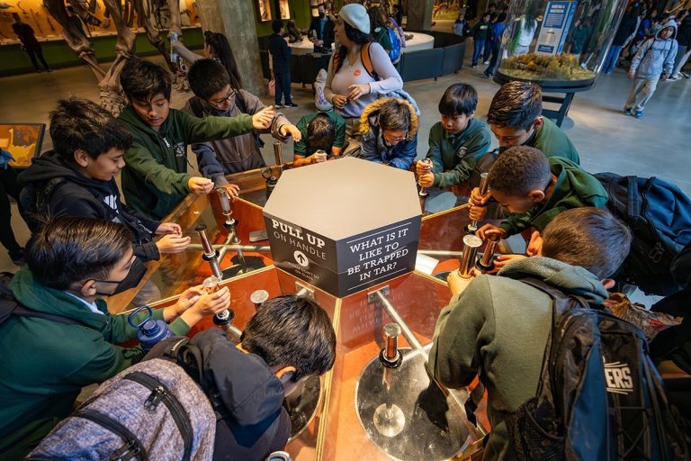 La Brea Tar Pits and Museum students at a hands on exhibit. Photo credit La Brea Tar Pits and Museum Faceboobk 768x512